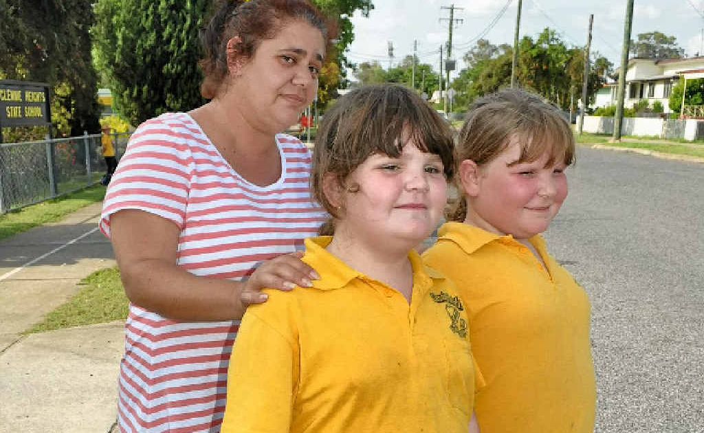 Glennie Heights State School parent Joann Cristina with Kasey Grimshaw and Sarah Grimshaw, look carefully before crossing outside the school.